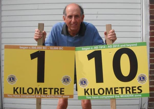 Bexhill-Hastings Link Road 10K race director Eric Hardwick with the 1 kilometre and 10 kilometre marker signs