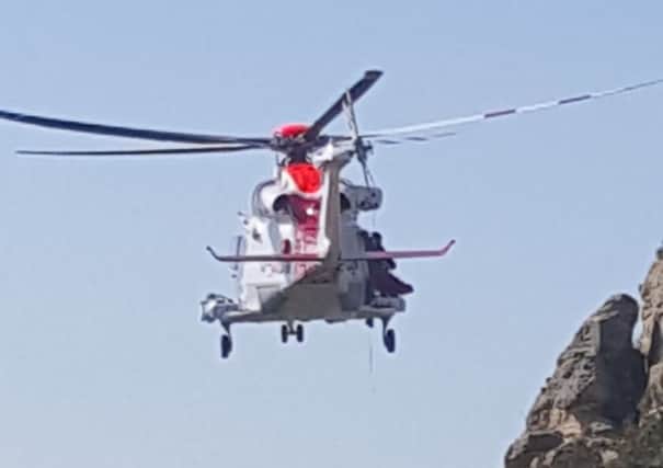 The coast guard helicopter rescued a woman from cliffs at Westhill   Pictures: Christian Southgate