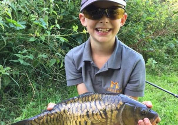 Ollie Kitchener with his prize carp