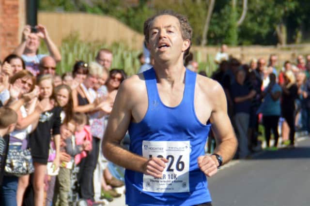 Daniel Anderson from Hastings AC crosses the line to win the Bexhill-Hastings Link Road 10K. Picture by Stephen Curtis (SUS-150921-070958001)