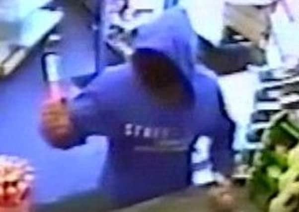 CCTV footage of the robber at Elm Grove Stores