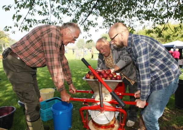 David Buckett, Mick King and Nigel Bowman pressing apples DM151179539a