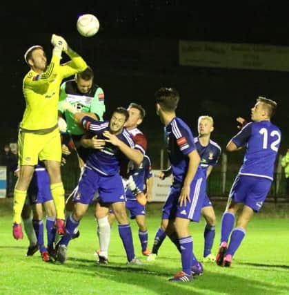 Hastings United goalkeeper Josh Pelling (green top) goes up for an added time corner during Tuesday night's defeat at home to Worthing. Picture courtesy Scott White
