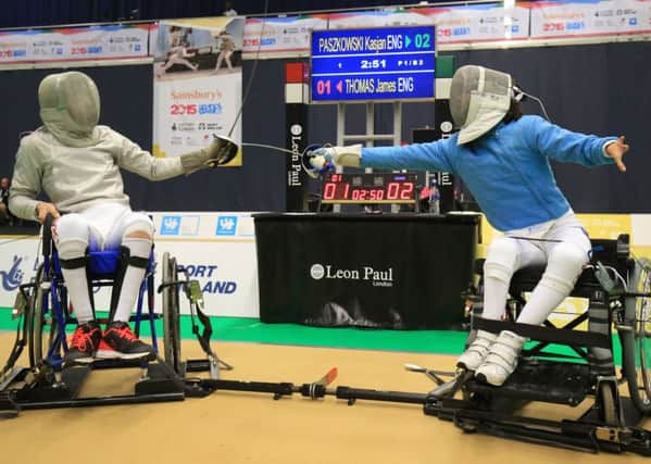 James Thomas (left) fights compatriot Kasjan Paszkowski in the mixed wheelchair fencing Sabre Pool at the Bolton Arena / Photo by Nigel French/PA Wire