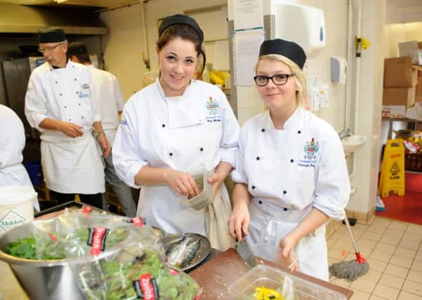 Daisy Madgwick and Hannah Perry prepare the food in the kitchen as 

students from Chichester College host the second of three special lunches at Brookfield Hotel, Emsworth 

Picture: Allan Hutchings