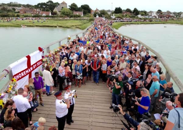 Mourners gather at the Tollbridge in Shoreham to observe a minute's silence in August