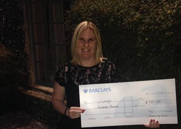 Epilepsy Lifestyle founder Marie Baker with the cheque