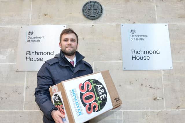 Steve Pickthall standing outside of the department for health with a box full over over 20,000 signatures. London SUS-150902-113335001