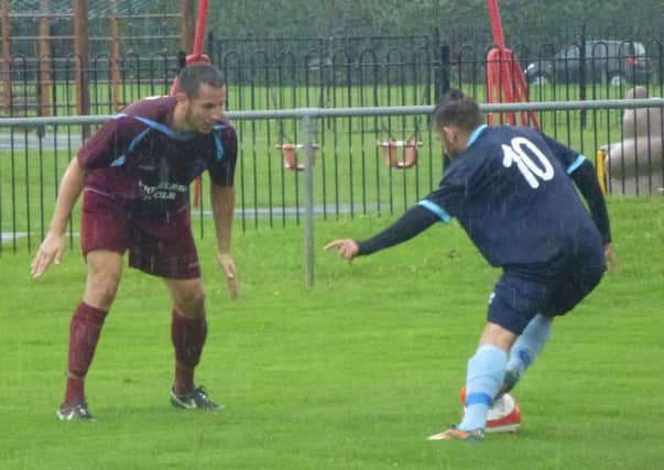 Steve Mote (left), who is suspended for Little Common's game away to Ringmer tomorrow, keeps a close eye on an opponent during August's reverse fixture. Picture by Simon Newstead