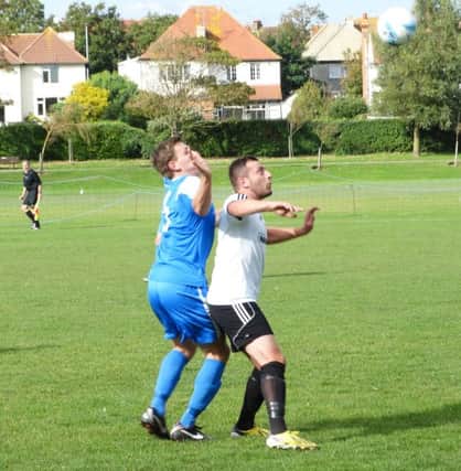 Bexhill United striker Sam Cooper holds off an opponent during last weekend's 5-1 loss at home to Haywards Heath Town. Picture courtesy Mark Killy