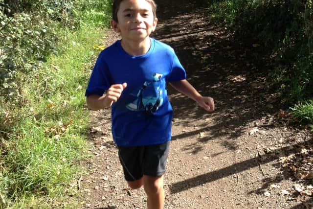 Ezra White, seven, from Horsham has completed a 10km run to raise £1,000 for his American aunt and uncle wanting to adopt a baby - picture submitted
