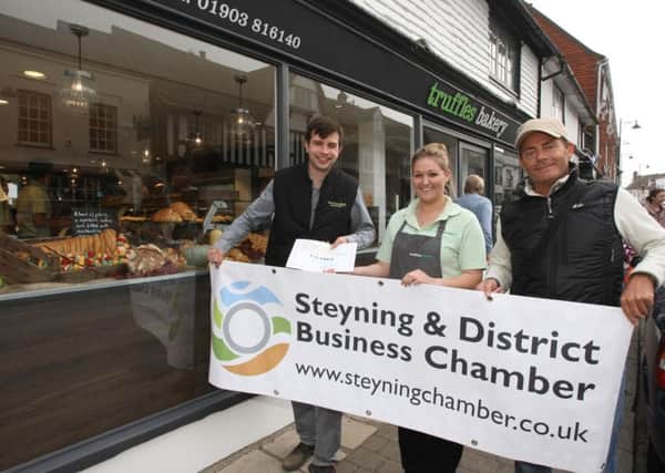 Best shop window display in Steyning - part of the Food and Drink Festival. Holly Dawson, assistant manager of Truffles Bakery, receives a certificate from Jack Dunkley (left) and Dean Haysom - food business catagory. Photo by Derek Martin