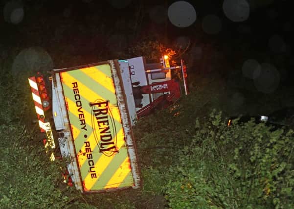 A recovery truck carrying a Range Rover ended up overturned in a field at Long Furlong last night   Pictures: Eddie Mitchell