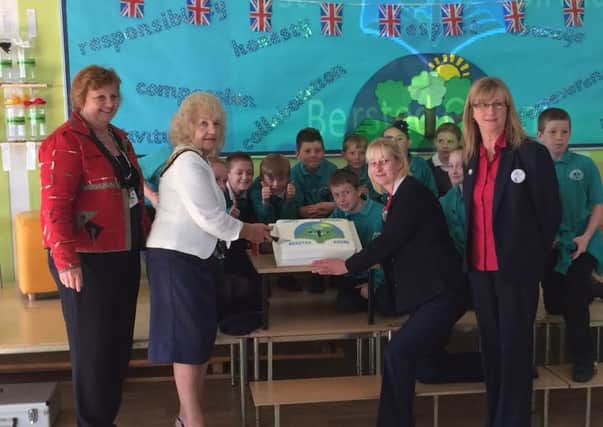 Cutting the cake to mark Bersted Green Primary Schools first birthday
