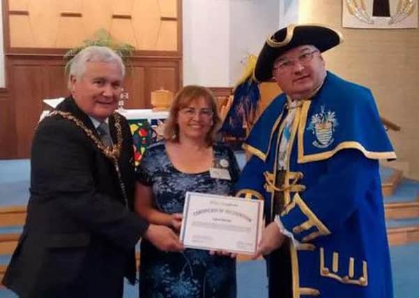 Carol Barber receives her Certificate of Recognition from Worthing mayor Michael Donin and town crier Bob Smytherman