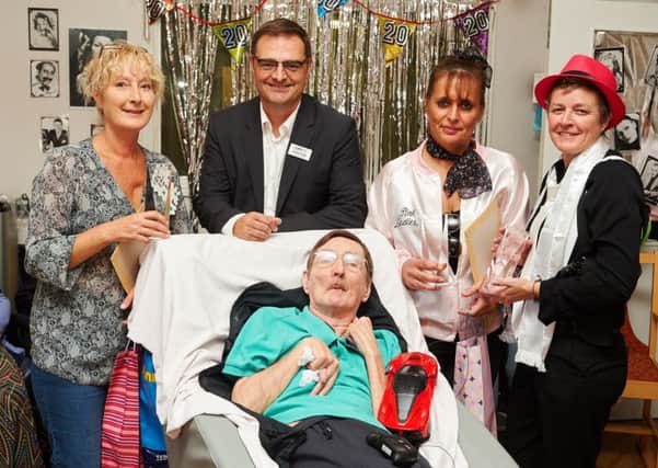 Staff Sally Munn and Sue Tipler, and resident Peter Liles, receive long-service awards from Care UK managing director Andrew Knight and home manager Fiona Wiederkehr. Picture: Simon Jacobs