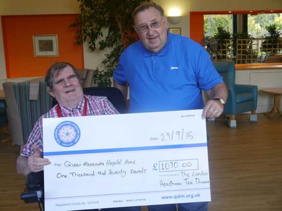 Charlie Johnson presenting the cheque to QAHH resident and former RAF Senior Aircraftman, Larry.