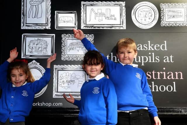 Children from The Lancastrian Infant School unveil their artwork display in Chichester