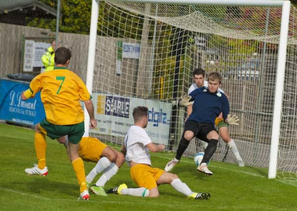 Joe Shelly scores Horsham's opener against Chichester Picture by Tommy McMillan SUS-151210-131526005