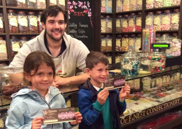 Kingslea Primary School pupils Sean Hughes and Kyla Smith with Joseph Crouch from Mr Simms Olde Sweet Shoppe in Horsham SUS-150211-150935001