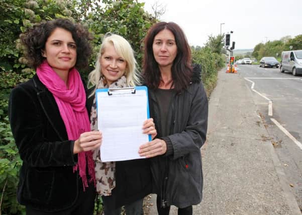 DM15221661a.jpg Petition launched to improve pedestrian safety near Clapham and Patching Primary School. L to R Alessandra Belelli, Solveig Avina and Barbara Paci. Photo by Derek Martin SUS-151210-165448008
