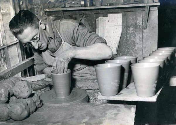 Peter's father, Charles Carver, working in Poling Pottery