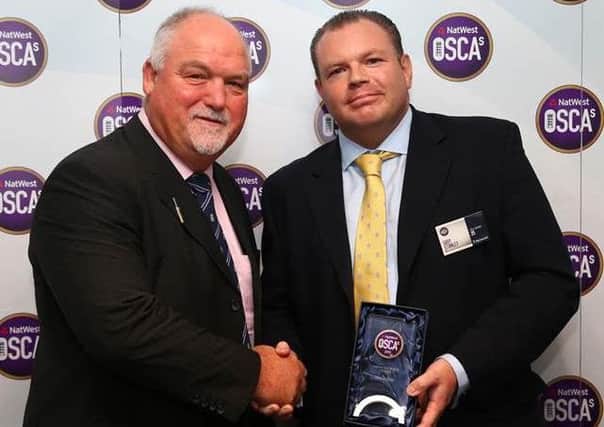 Gary Stanley receives his award from Mike Gatting