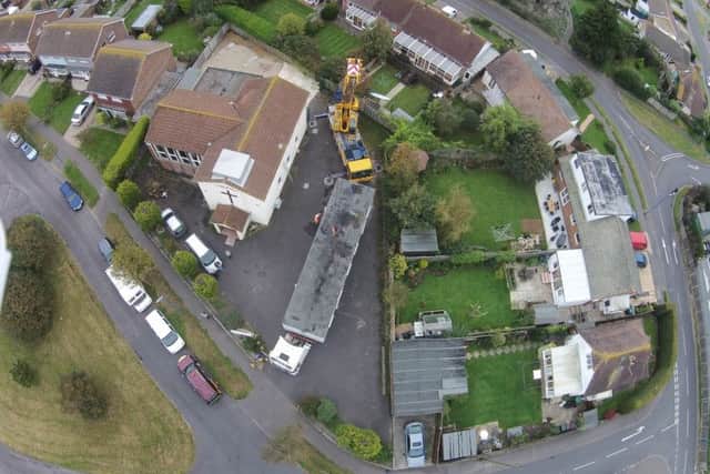 An overhead drone shot of the crane lifting the cabin. Picture by Alistair Ghinn