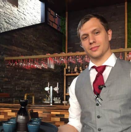 Senior bartender Matthew Forrest serving popular cocktail Warm Honey Bee