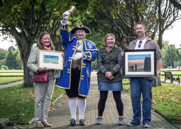 Rosemary Jones with her painting 'South Downs', Bob Smytherman, Joanna Richards and Adam Hurley with his painting 'Sunset Groyne, Worthing'  Picture: Alan Cross