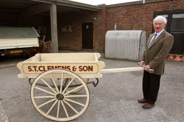 DM15221961a.jpg S.T. Clemens & Son, builder in Chichester, closing down after nearly 100 years. Owner Jeremy Clemens, pictured with an original handcart. Photo by Derek Martin SUS-151016-180238008