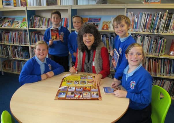 Author Caroline Lawrence with some of the pupils at River Beach Primary School