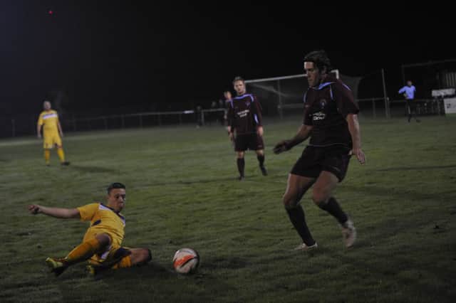 Little Common midfielder Billy Trickett in the thick of the action against Langney Wanderers last night. Picture by Simon Newstead (SUS-151021-103611002)