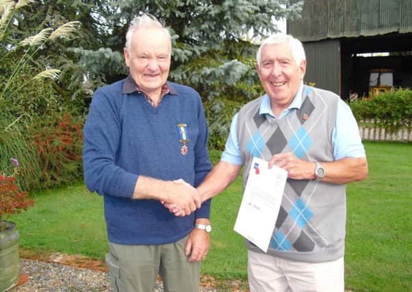 John Dumbrell of Bines Green, Ashurst, pictured receiving his award for 45 years as a Poppy Appeal collector from the Chairman of the Royal British Legion, Steyning and District Branch, Lewis Whittaker