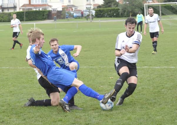 Josh Elliott-Noye and Cameron Burgon get stuck in for Bexhill United against Storrington. Picture by Simon Newstead (SUS-151018-013330002)
