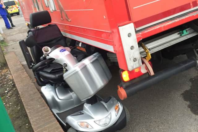 The mobility scooter's arm rest was wedged under the lorry