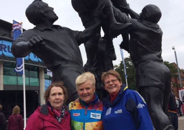 Bognor Regis friends Julie Gillson, Jenny Hicklin and Margaret Murphy by the iconic sculpture of a rugby line-out at Twickenham Stadium