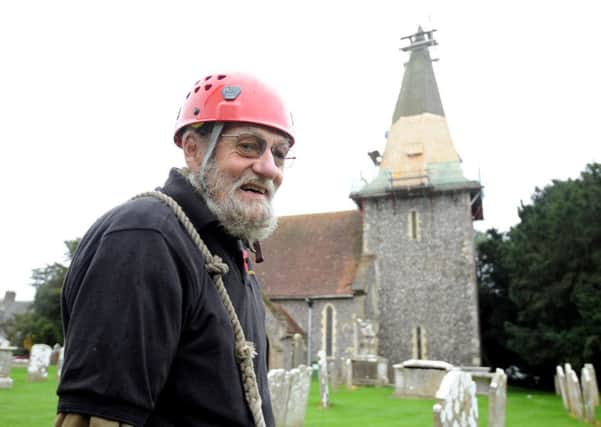 Peter Harknett is working on St Andrew's Church, in Oving. Picture by Kate Shemilt