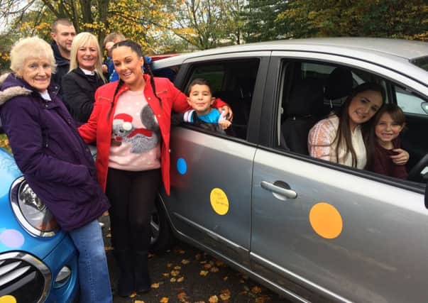 Lauren Dougan, 27, from Bognor, behind the wheel and with her family ahead of her drive