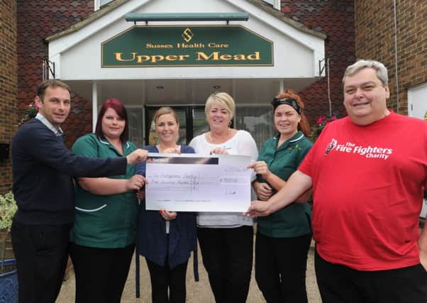 Upper Mead Care Home in Henfield cheque presntation to Fire Fighters charity (Pic by Jon Rigby) SUS-151019-201047008