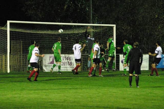 Horsham YMCA's Dan Pollard (white) far right scores their second goal. Photo by Clive Turner