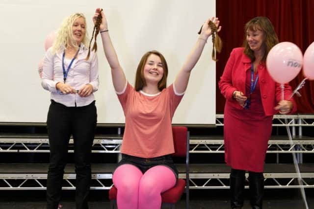 Head girl Olivia Francis has her plaits cut off for charity