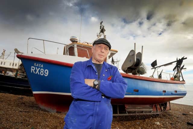 Hastings Fishermen's Society chairman Paul Joy with his boat on Hastings beach. SUS-150411-134401001