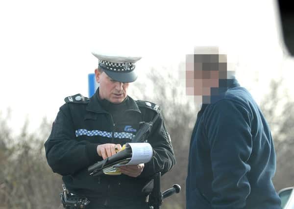 Norfolk Police crackdown on drivers using mobile telephones. Pc Stephen Bodle issues a driver with a fixed penalty notice for using the phone whilst driving.