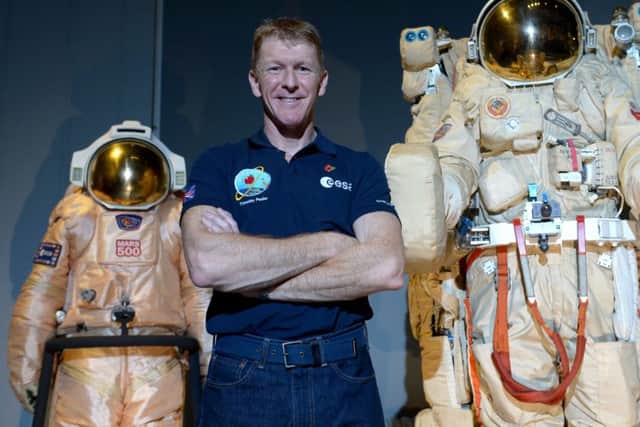 British astronaut Tim Peake poses beside spacesuits as he talks to UK media at the Science Museum, London, before being launched into space PICTURE: Anthony Devlin/PA Wire1