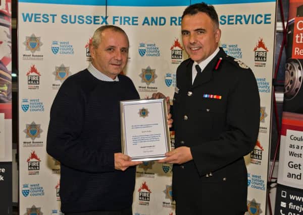 Kevin Archer receiving his award from chief fire officer Sean Ruth