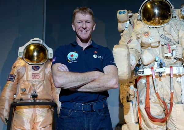 British astronaut Tim Peake poses beside spacesuits as he talks to UK media at the Science Museum, London, before being launched into space Picture: Anthony Devlin/PA Wire