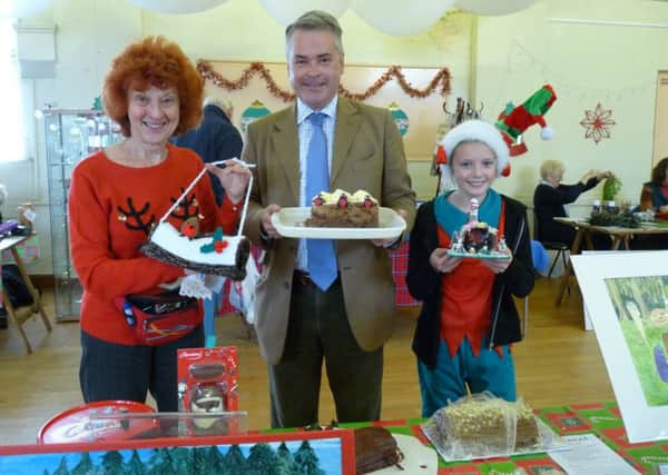 East Worthing and Shoreham MP Tim Loughton at last year's Christmas fair with yule log winners Cherry Fraser, left, and Freya Canning