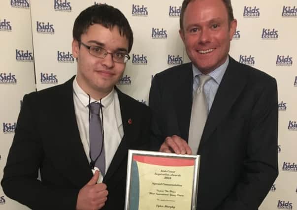 Tyler Murphy being presented with the Most Inspirational Young Person award by MP Nick Herbert at the 9th Annual Kids Count Inspiration Awards Evening
