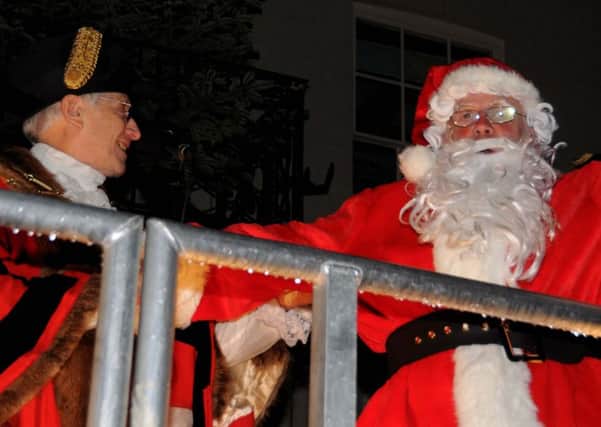 Former Rye mayor Sam Souster greets Santa outside the George Hotel in the 2009 Christmas festival. Picture by: TONY COOMBES PHOTOGRAPHY